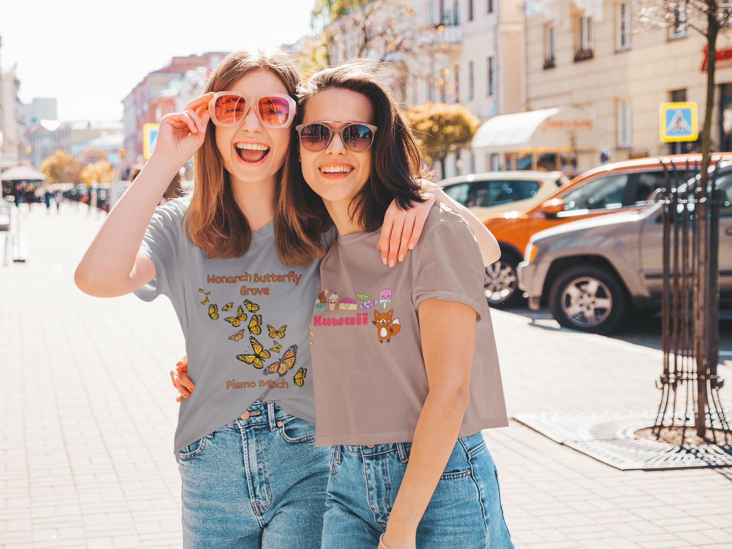 picture-of-two-happy-friends-wearing-a-crop-top-with-kawaii-written-on-it-and-cute-japense-characters-and-a-t-shirt-with-monarch-butterfly-grove-pismo-beach.png