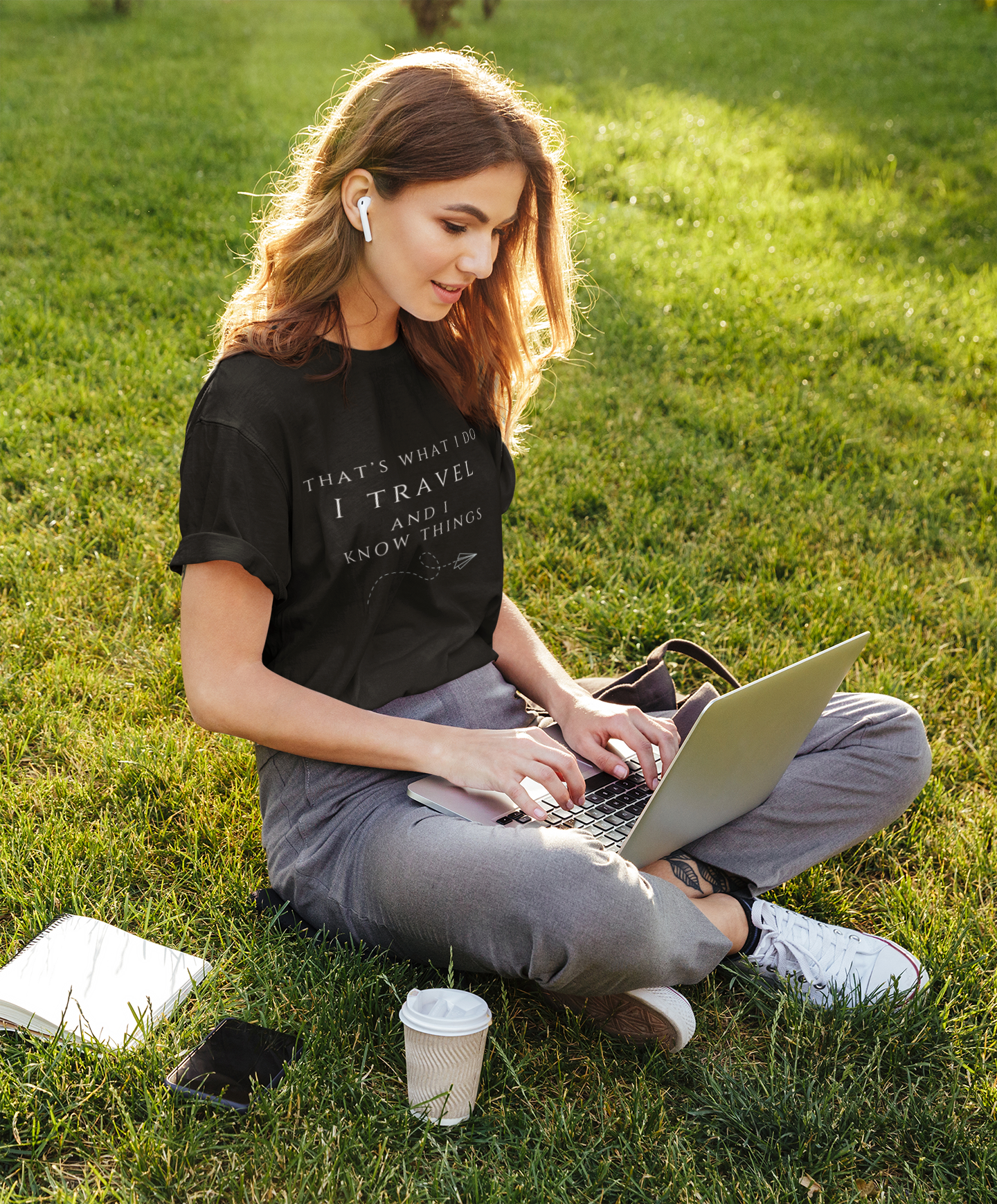 Zay-la-vee-t-shirt-that-says-i-travel-and-know-things-mockup-of-a-young-woman-working-at-a-park